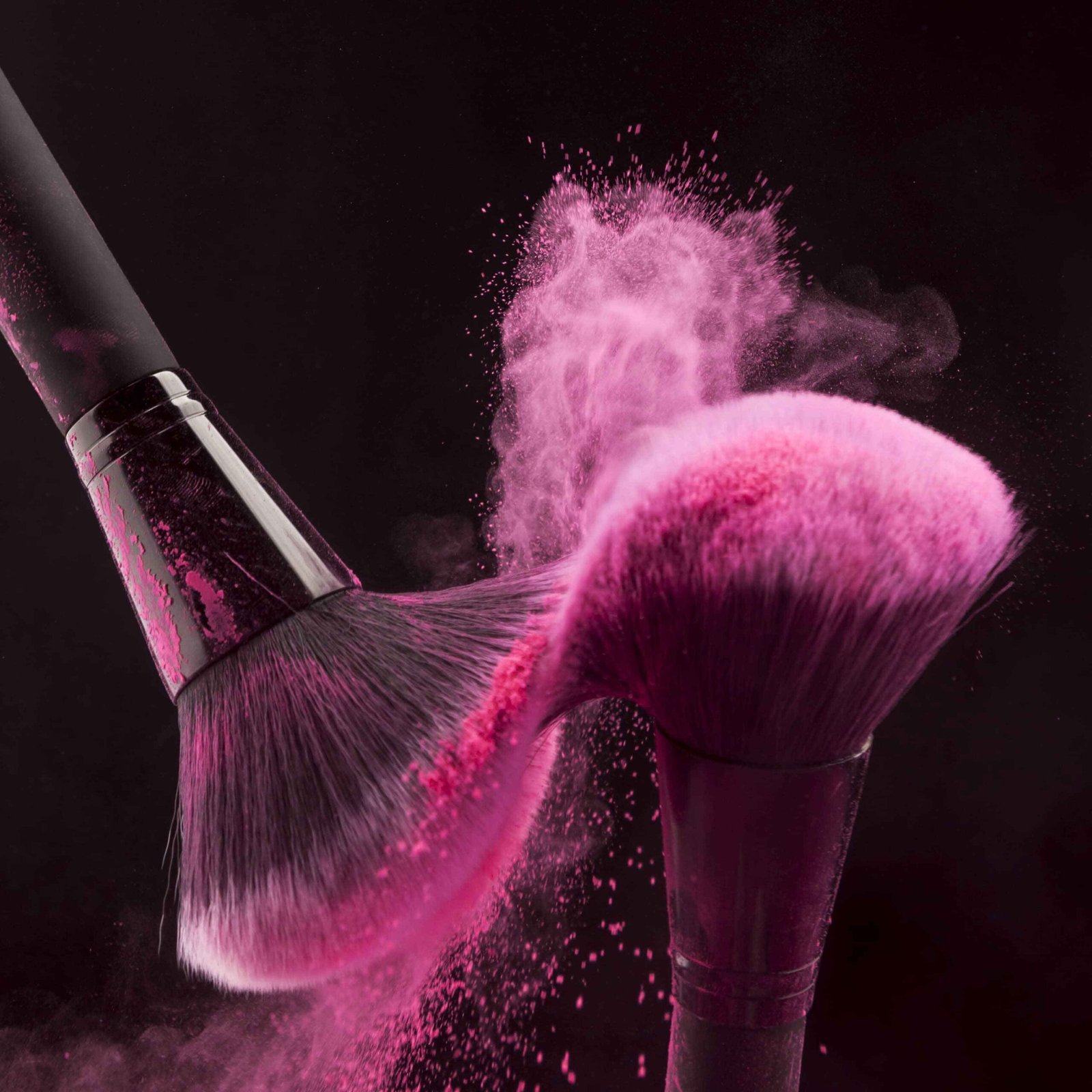 Makeup brushes with pink powder haze