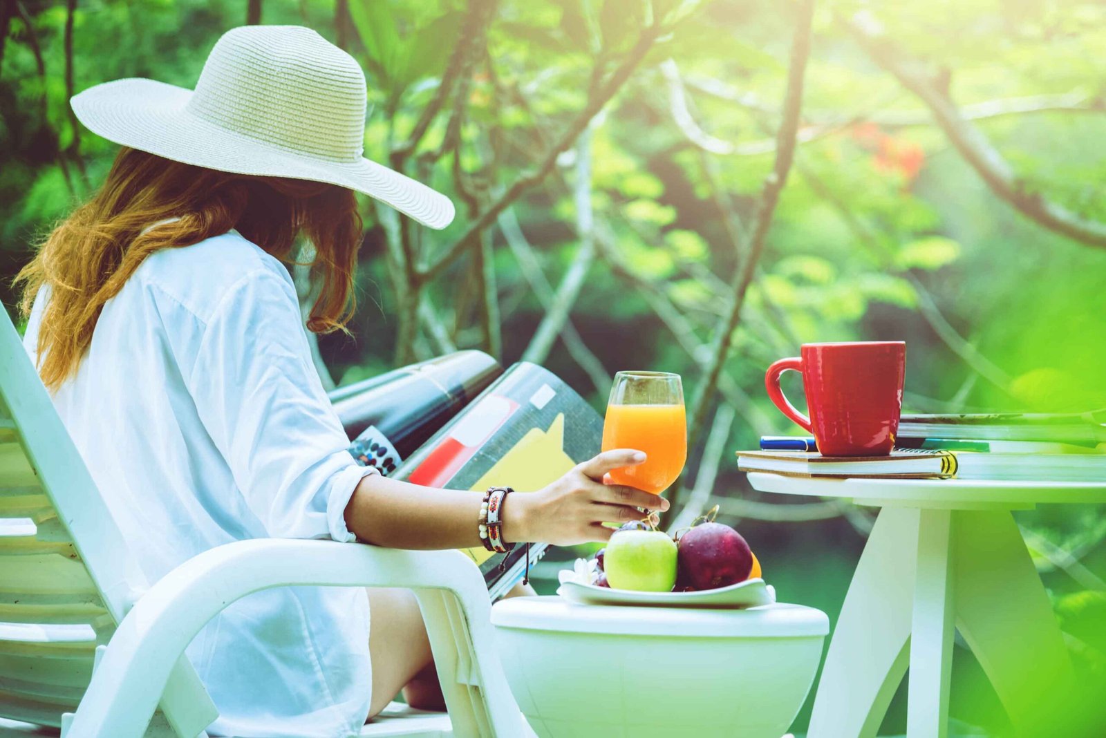 Side view woman reading magazine while sitting forest